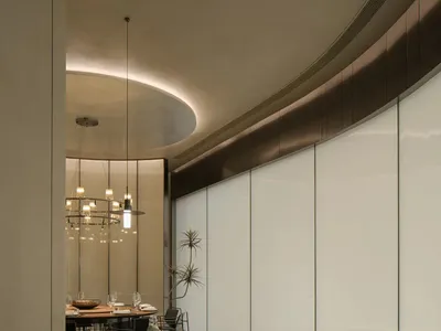 Modern restaurant interior with glass wall, wooden floor, and metallic accents.