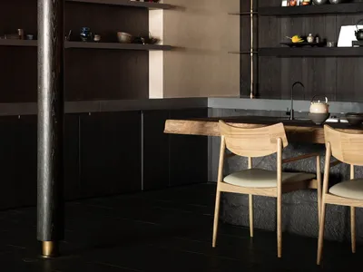 Minimalist residential kitchen with wooden and stone elements.
