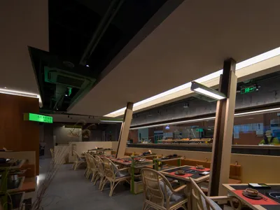 Modern industrial restaurant interior with concrete and glass materials.