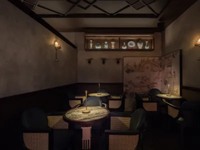 A minimalistic restaurant bar with wooden furniture and decor.