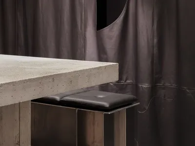 Concrete and metal dining counter in a minimalist restaurant interior