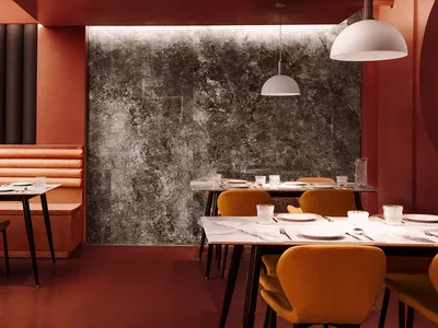 Industrial-themed restaurant interior with marble and concrete finishes.