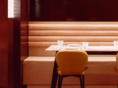 Modern restaurant booth seating with fabric seating and a polished floor.