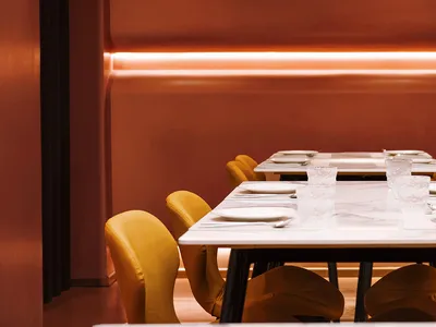 Modern restaurant interior featuring a sleek restaurant interior with concrete walls and a minimalist design.