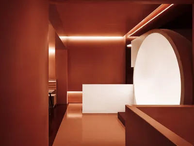 Terrazzo interior of a modern restaurant with a white archway and minimalist design.