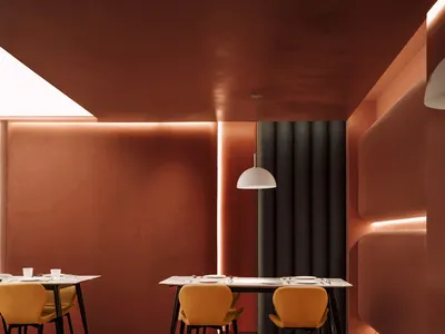 A modern restaurant interior with metal furniture and white pendant lights.