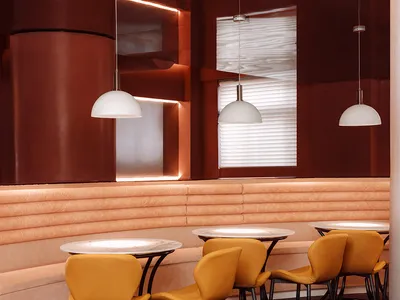 Modern industrial restaurant interior with metallic walls, leather seating, and matte finishes