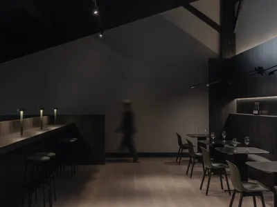 現代工業風餐廳室內空間，融合混凝土與木質元素。