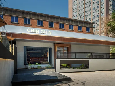 Modern restaurant exterior with concrete and steel structural elements.