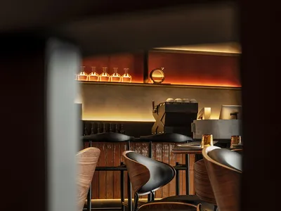 Interior view of a restaurant with a modern industrial design featuring wood and leather elements