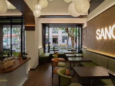Modern cafe interior with wooden tables and upholstered seating