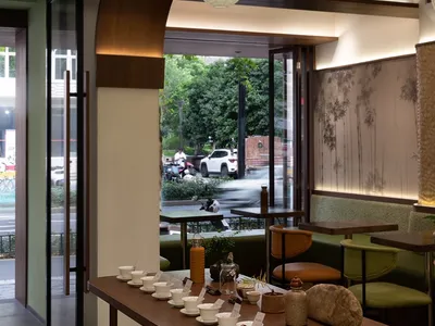 Modern restaurant interior with paper lanterns and wooden decor.