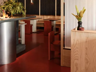 A modern restaurant interior with wooden fixtures and a warm, inviting atmosphere.
