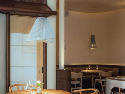 Modern dining room with wood table, fabric chairs, and metal accents.