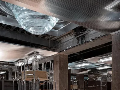 Industrial-style restaurant interior with concrete, glass, and metal elements