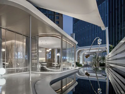 Modern hotel suite featuring sleek glass, concrete, and marble interiors