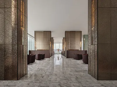 A modern hotel lobby featuring metallic-textured walls and marble floors.