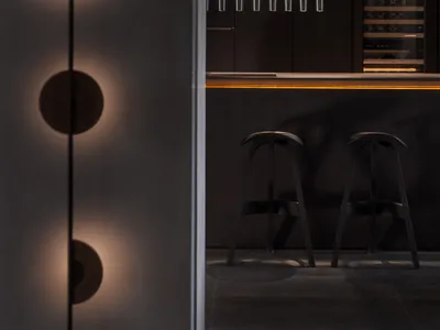 A modern kitchen with metallic finishes and minimalistic design.