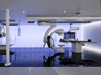 Medical imaging suite with a patient undergoing treatment and a modern design.