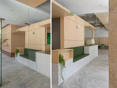 Modular seating arrangement in a restaurant with concrete flooring, wooden walls, and glass partitions.
