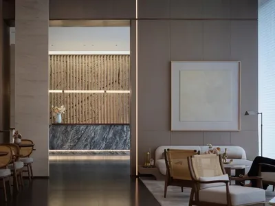 Modern hotel lobby with wooden accents and marble features