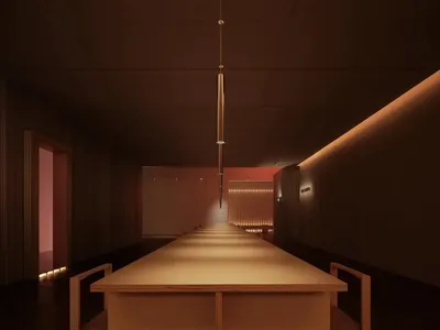 A minimalist restaurant interior with a long wooden table and modern lighting fixtures.
