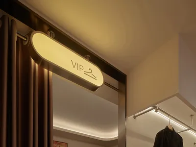 A luxurious VIP room with metallic textures in a high-end retail setting.