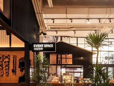 Industrial-themed restaurant event space featuring wood accents, concrete flooring, and metal accents.