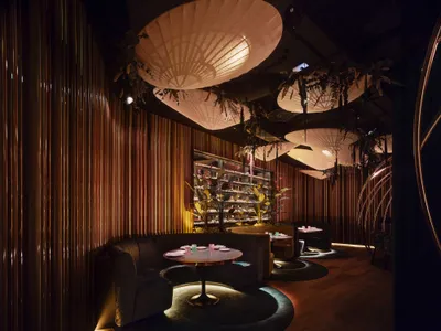 A modern restaurant interior featuring wooden elements and contemporary design.