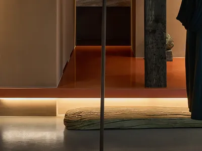 Modern minimalist bedroom with wood accents and a warm, inviting atmosphere.
