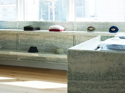 Concrete retail space showcasing shelves and hats.