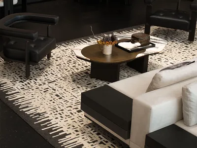 Modern living room with white and black furniture, marble coffee table, and white rug.