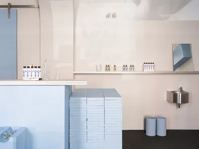A modern restaurant interior with blue painted walls and minimalist decor.