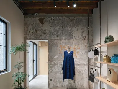 Concrete retail storefront with industrial-style design and wooden accents.