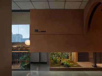 Industrially designed restaurant interior with concrete and glass elements.