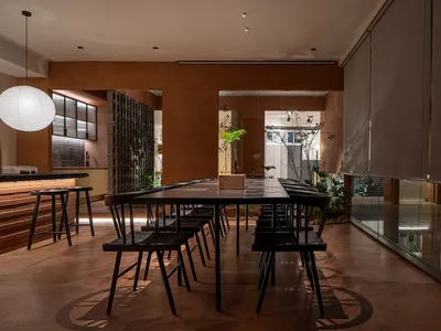 Modern, industrial-style restaurant interior featuring concrete and glass elements
