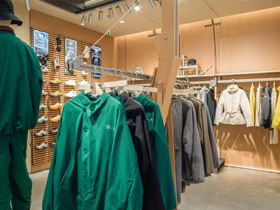 具有現代設計的零售店，陳列服裝架與鞋子展示區。