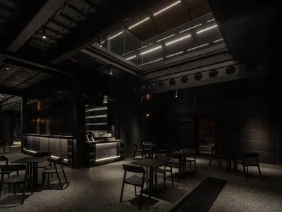 Industrial-themed restaurant interior with metallic finishes and dark color palette.