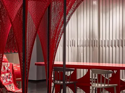 Modern, industrial-style restaurant interior with metallic walls and tables