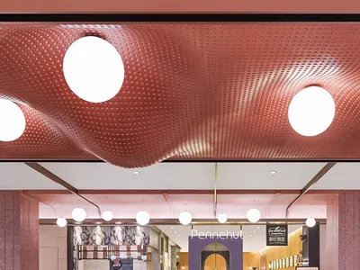 Modern restaurant interior with marble, terrazzo, and metallic accents