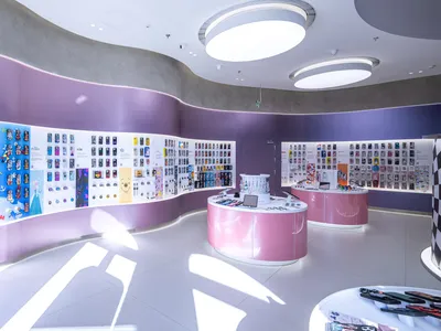 A retail storefront showcasing various Disney-themed merchandise on a purple wall.