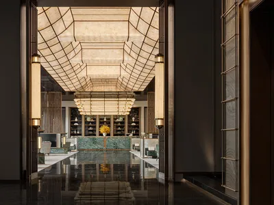 A modern hotel lobby featuring marble, glass, and metal elements.