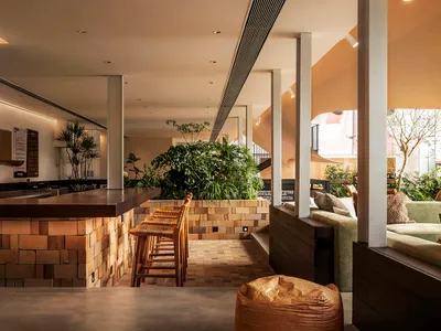Interior design of a coffee shop featuring brick and concrete materials.