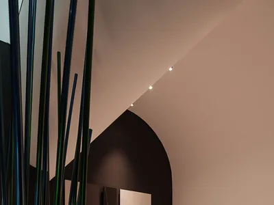 A modern restaurant with metallic decor and marble countertops.