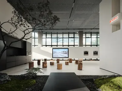 現代廚房展示空間，配有木質吧台椅與大型螢幕，螢幕上顯示雪景。