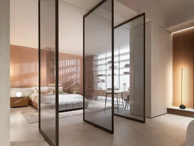 Modern bedroom with glass walls and concrete floors