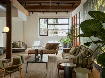 Natural and plush living room with industrial elements and soft textiles.