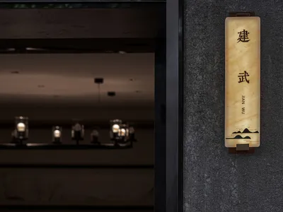Marble restaurant interior with elegant lighting and signage