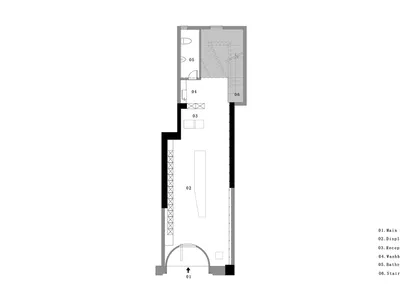 A grey-scale architectural floor plan of a showroom with concrete walls and a staircase.
