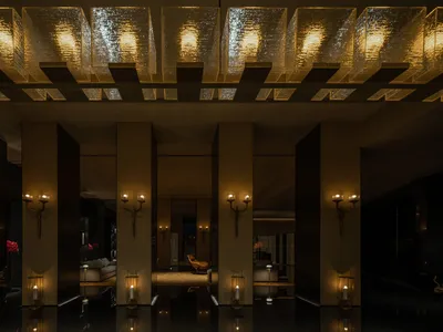 An elegantly designed hotel lobby featuring modern neoclassical fixtures and decor.